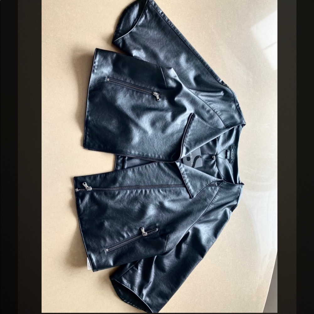 Black cropped leather jacket, with zipper pockets.